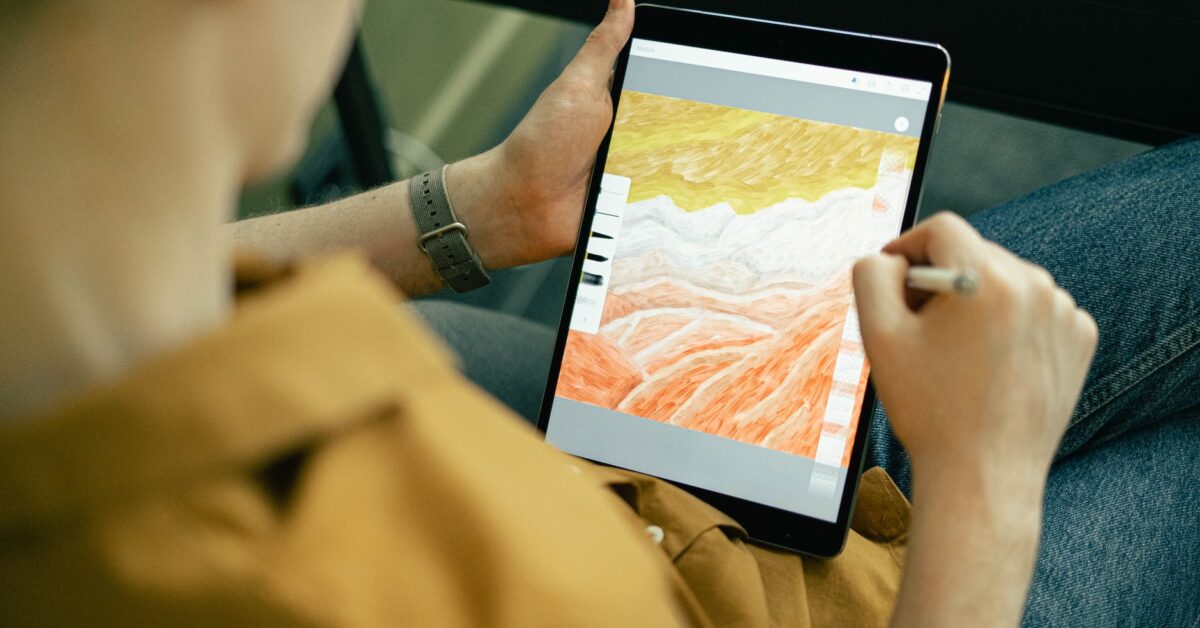 person drawing on a tablet